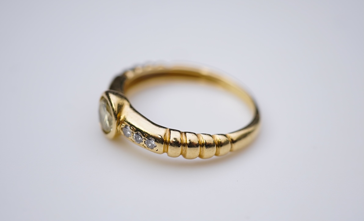 A yellow diamond and diamond ring